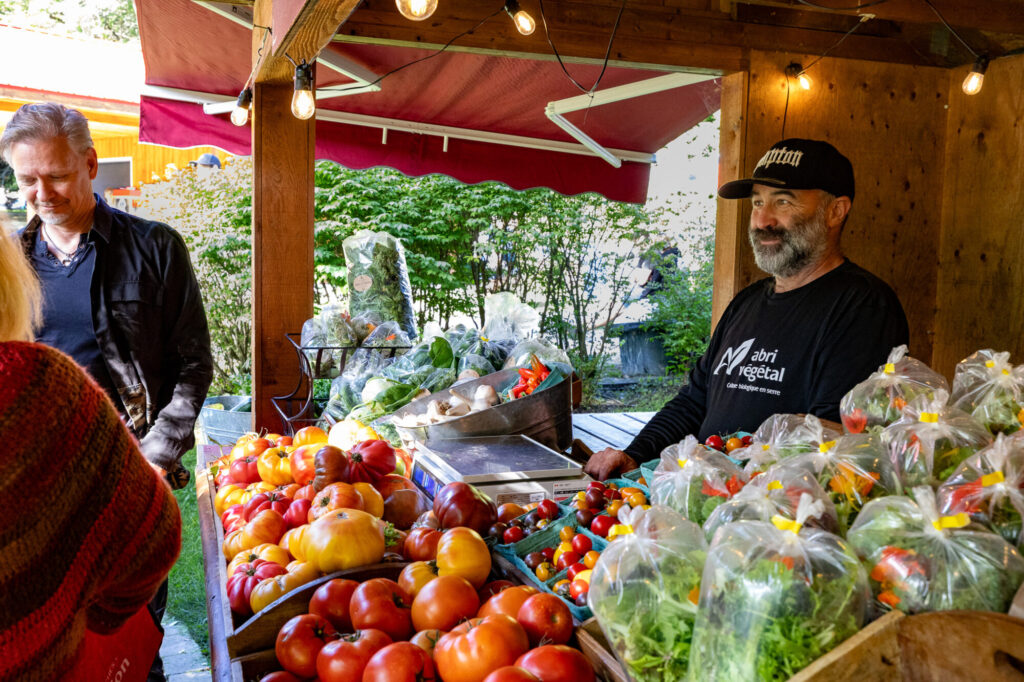 Maraîcher et étal de tomates et légumes frais au Marché public de Compton