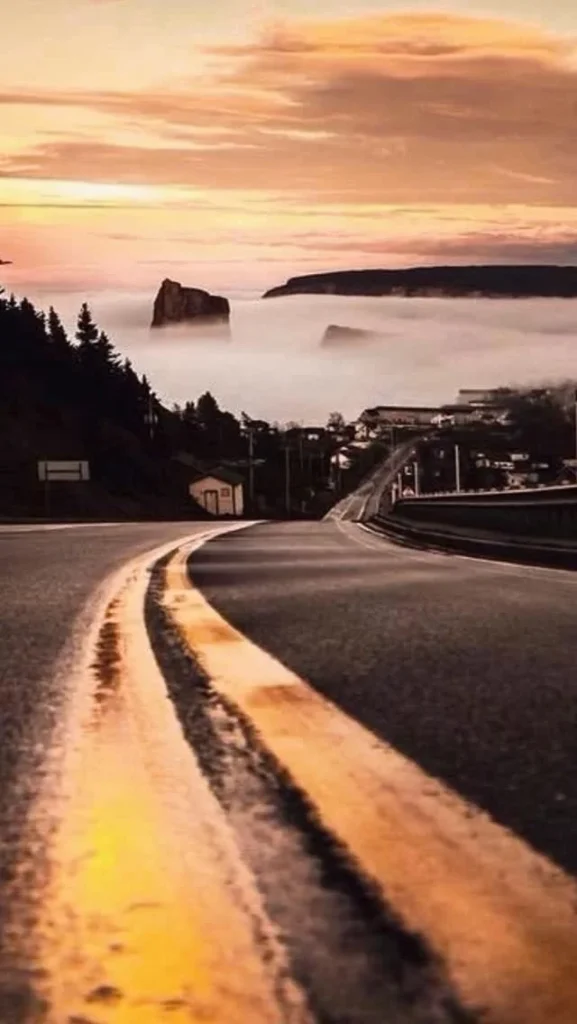 Route de la Gaspésie au lever du soleil, avec le rocher Percé dans la brume